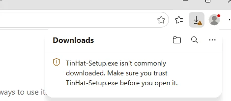 Edge's download panel: TinHat-Setup.exe isn't commonly downloaded. Make sure you trust TinHat-Setup.exe before you open it.